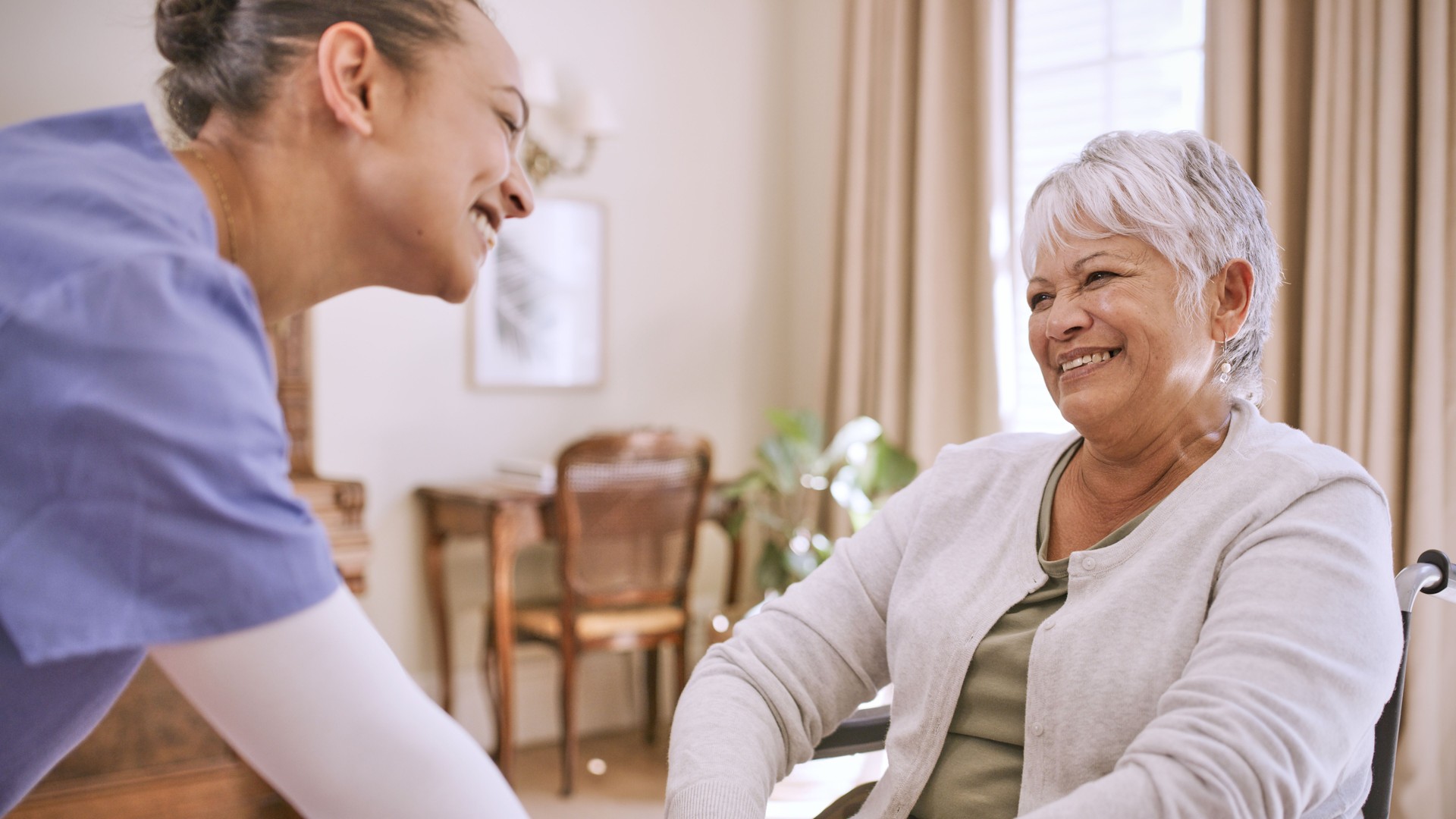 Shot of a young nurse caring for a senior woman in a wheelchair